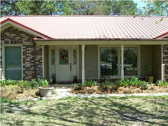 Rocking chair front porch says "come on up & have a glass of sweet tea".