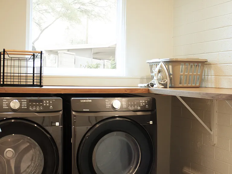 In-unit washer and dryer with dedicated laundry space.