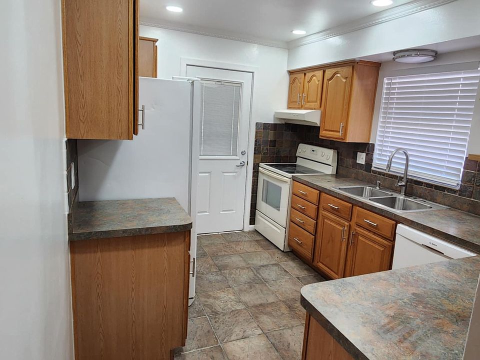 Large kitchen with tons of wood cabinets for great storage.