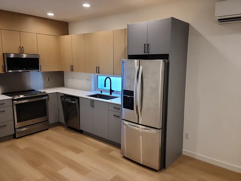 Kitchen with upgraded fridge and cabinetry.