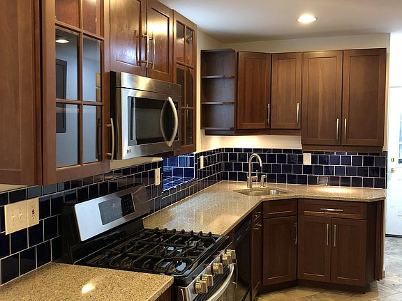 Recently remodeled kitchen with stainless steel LG appliances and quartz countertops.