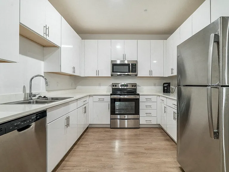 Enjoy stainless-steel appliances and quartz countertops in our contemporary design scheme.