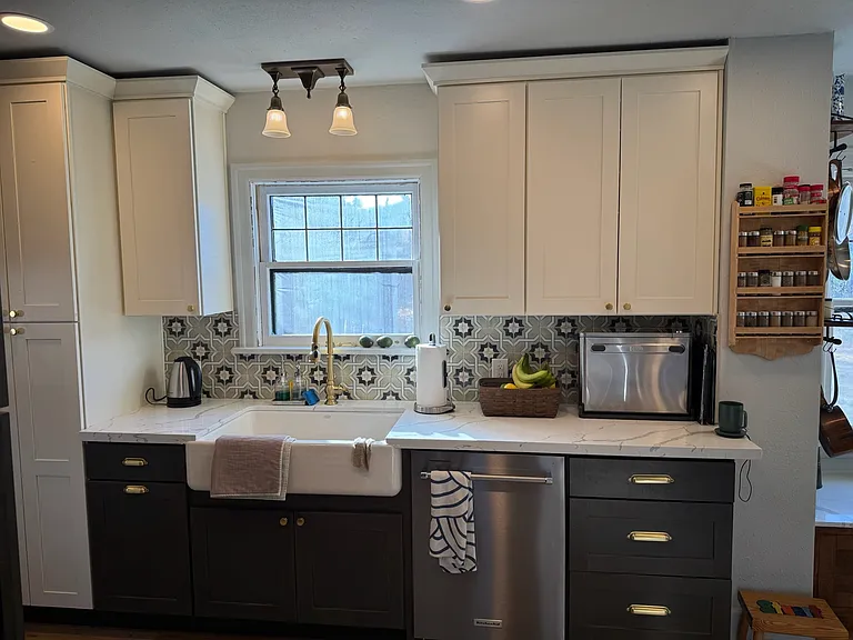 Newly renovated kitchen with farmhouse sink, stainless steel appliances, quartz counter, plenty of storage, gas range and custom woodwork.