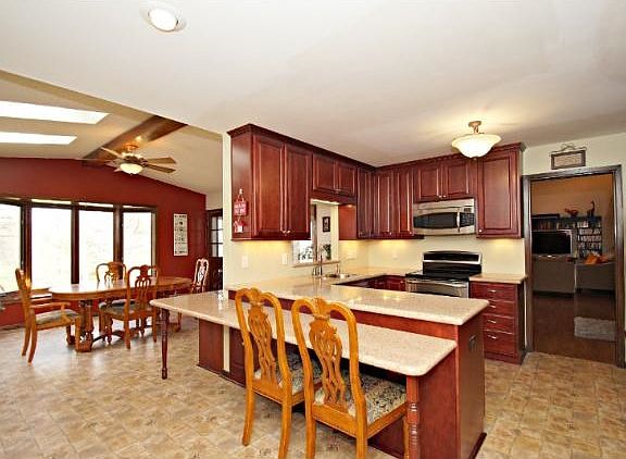 Large kitchen that leads you into the formal dining room with bay window that overlooks the large backyard.