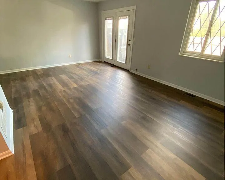 another view of the living room and the back door, which leads to a fenced-in private patio and beyond that, off street parking for 2 cars