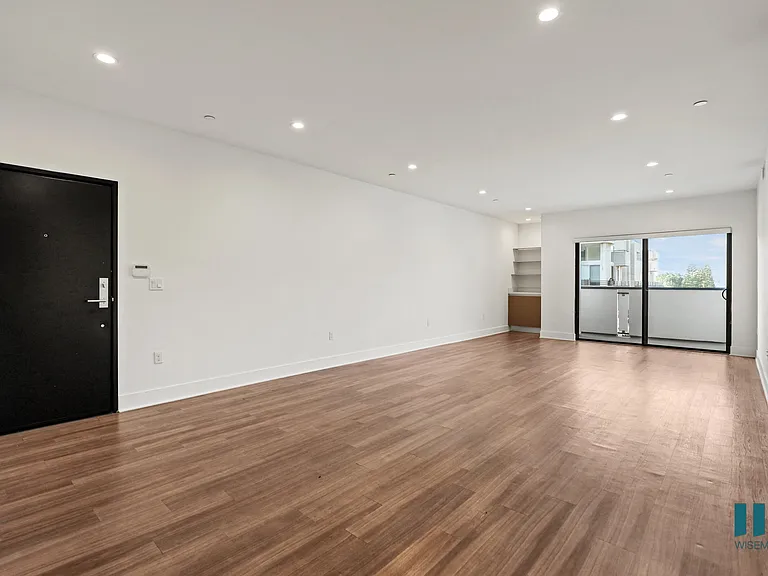 Front Entrance, Living Room with Built-In Cabinet, Shelving, Vinyl Flooring, Recessed Lighting, and Patio
