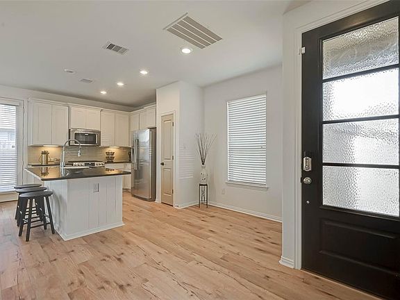 This home showcases exquisite design and attention to detail. Stunning laminate floors greet you upon entry.