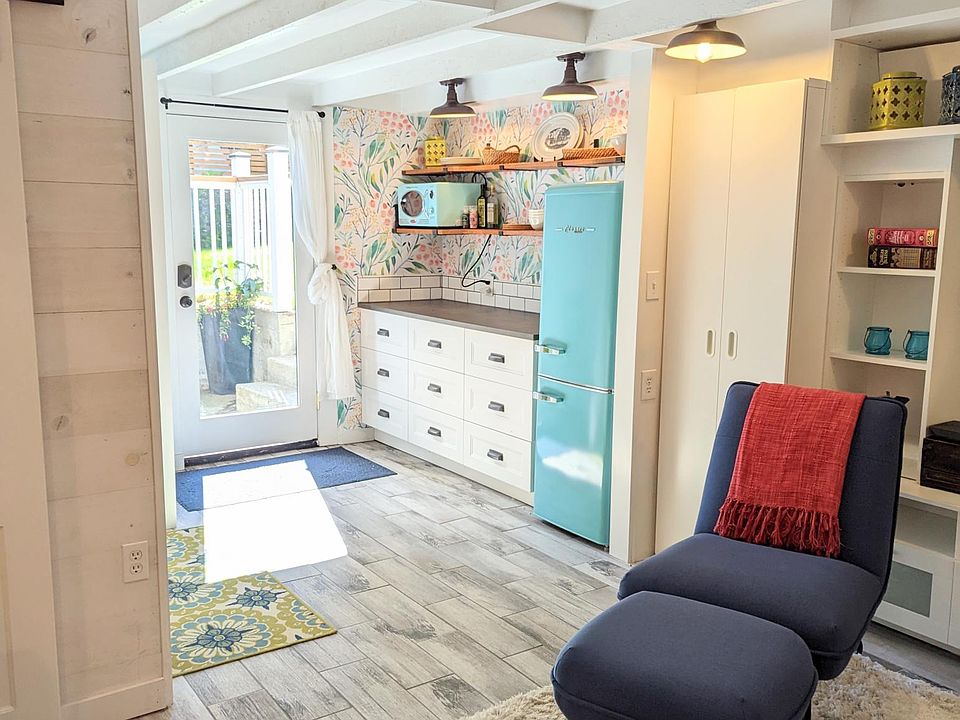 Kitchen with new retro-style appliances--induction cooktop, microwave, refrigerator/freezer, toaster/convection oven. Includes all pots, pans, utensils, and dishes for all of your cooking and dining needs.