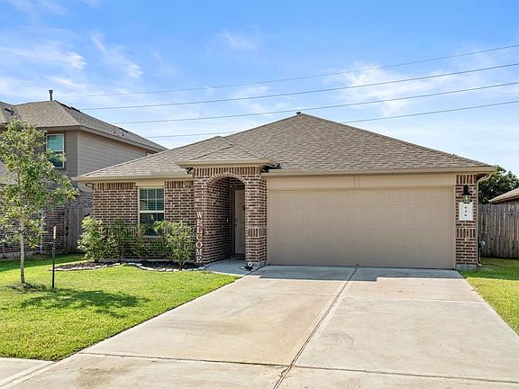 The gorgeous neutral brick of the home is beautifully enhanced by the complimentary neutral paint of the garage & trim. The paint of the home is a great way to balance the brick w/ the color of the roof.