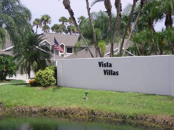 Landscaped entrance with small pond.