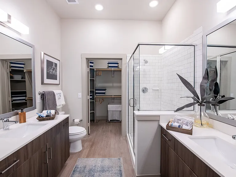 Double Vanity Bathroom with Frameless Glass Shower and Walk-In Closet