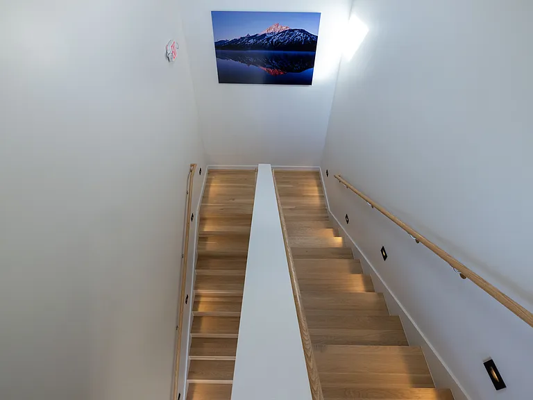 Staircase to the upper floors with artwork on the landing.