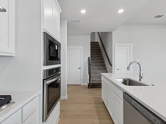 Kitchen in the Stanley II home plan by Trophy Signature Homes - REPRESENTATIVE PHOTO