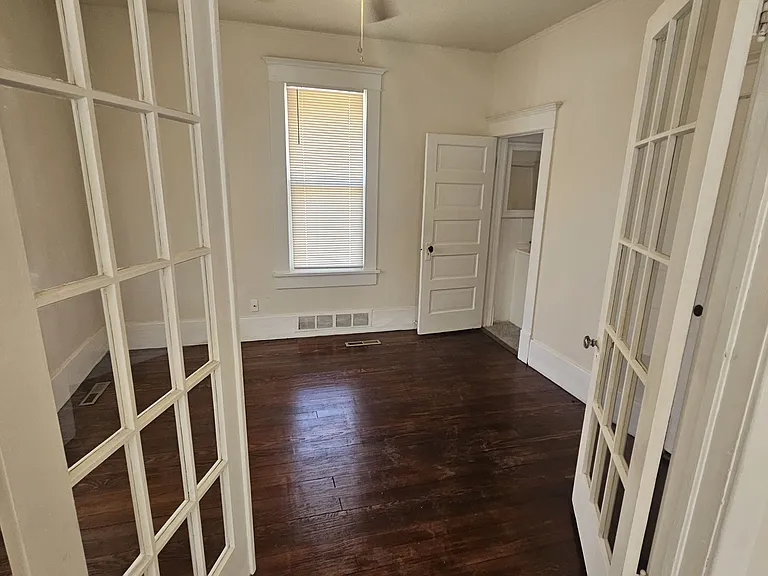 Wood flooring in this room with high ceilings. Door in back leads to the upstairs bathroom. Ther is a walk in closet in the room as well.