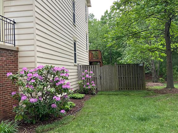 Side of house leading to fenced lawn
