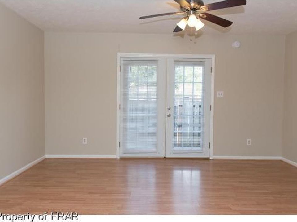 The open-concept area has fresh paint and new blinds that leads to the french doors and fenced patio.