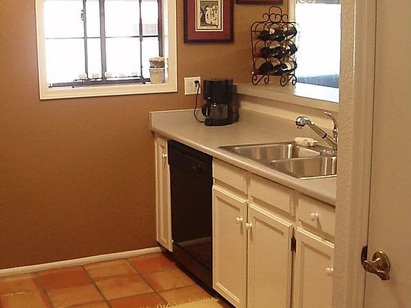 Polished saltillo tiles, new SS sink and breakfast bar for casual dining.