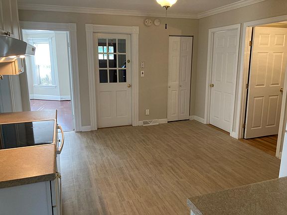 Kitchen and utility closets (2) with view into living room and front door.