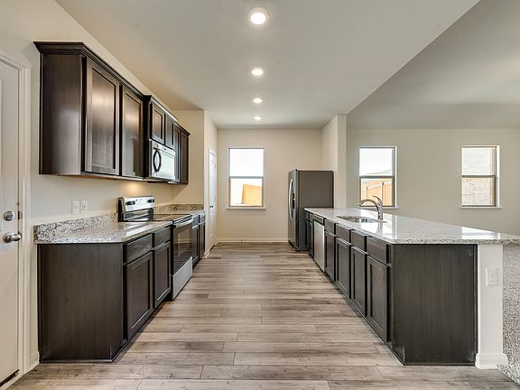Enjoy stunning granite countertops and designer wood cabinetry in this kitchen.