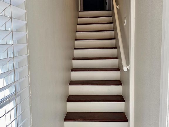 Stairs lead to the unit.