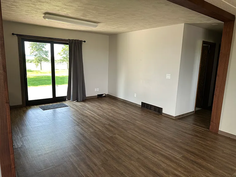 Dining room with patio doors facing the acreage, walking out to the deck.