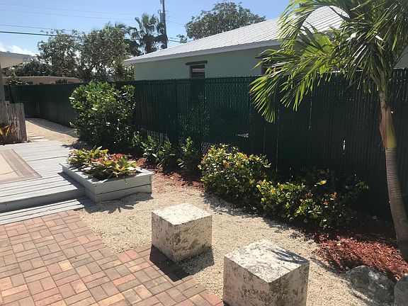 Tropical wood and brick decks with cut coral seating cubes