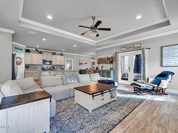 Large open concept living area. Screened in porch out the French doors.