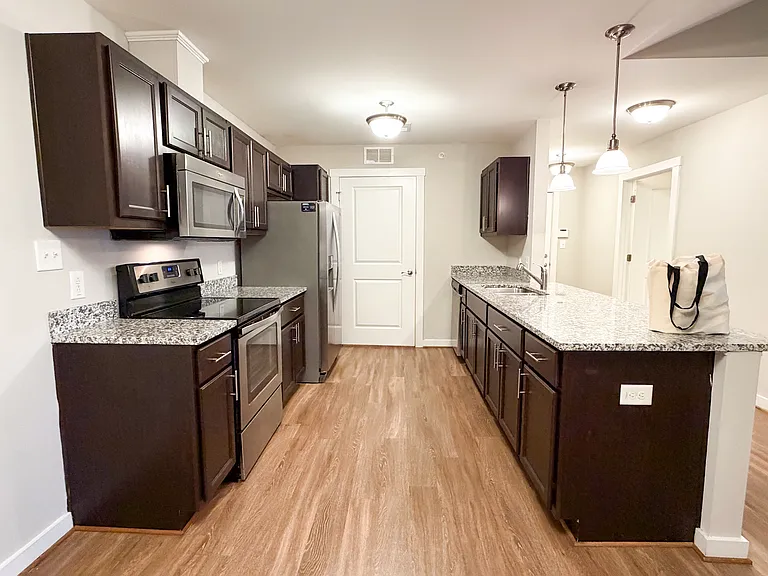 The kitchen features granite countertops and stainless steel appliances.
