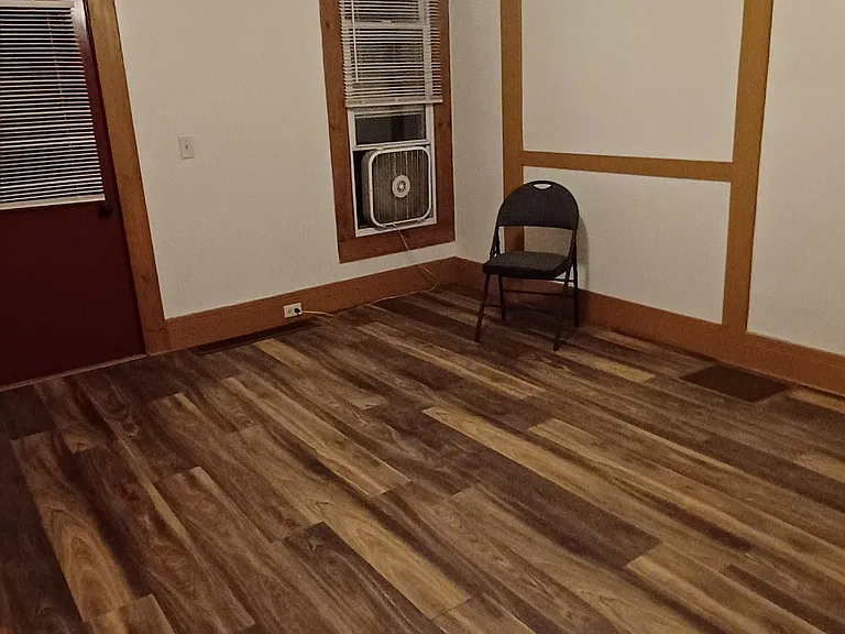 Living Room has one window and a second entry door from driveway.
