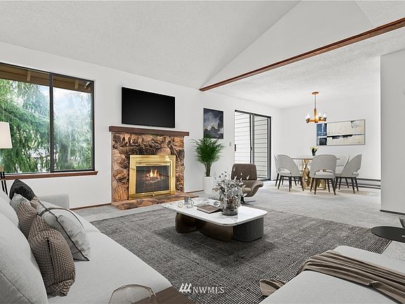 Cozy living room with fireplace opens into dinning room