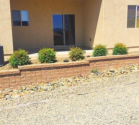 Patio, windows from left to right are kitchen, slider to dining area, master bedroom. There is a 3' wide brick walkway That extends the depth of the patio and leads to the back yard, lockable gate.