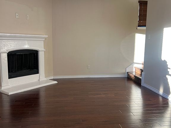 Living room with fire place and fan