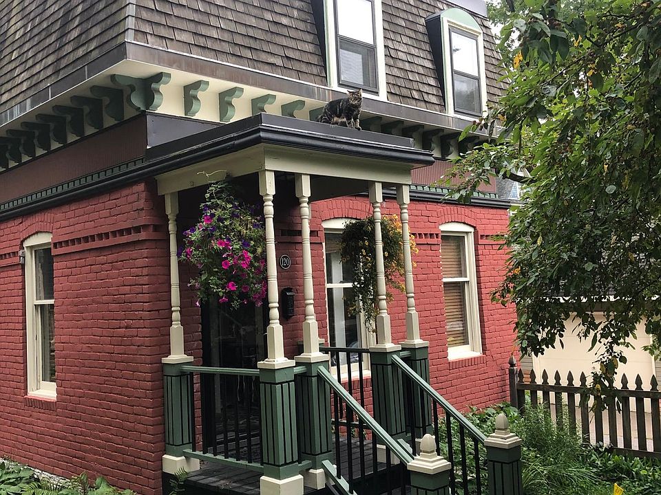 Adorable cottage with front porch, ornate features. Cherry tree blooms every May.