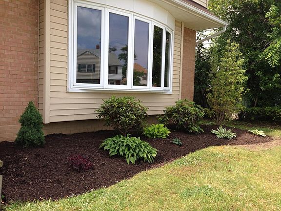 Updated landscaping. Living room with wood floors faces the front of the home and the family room with tile floors is in the back of the home.
