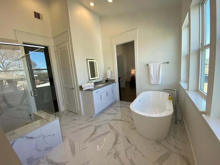 Master bathroom, all marble with lighted mirrors. Includes luxurious soaker tub.