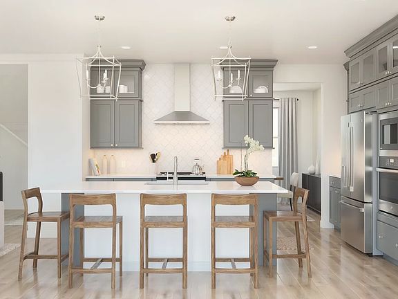 Kitchen with glass upper cabinets and pendant lighting