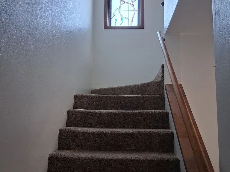 Stairs to second level with large bedroom and ensuite full bathroom