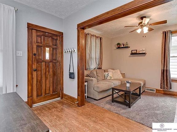 Original woodwork, original hardwood floors, and ceiling fans throughout