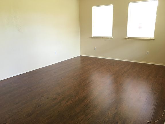 Living room features new flooring and plenty of natural ligh