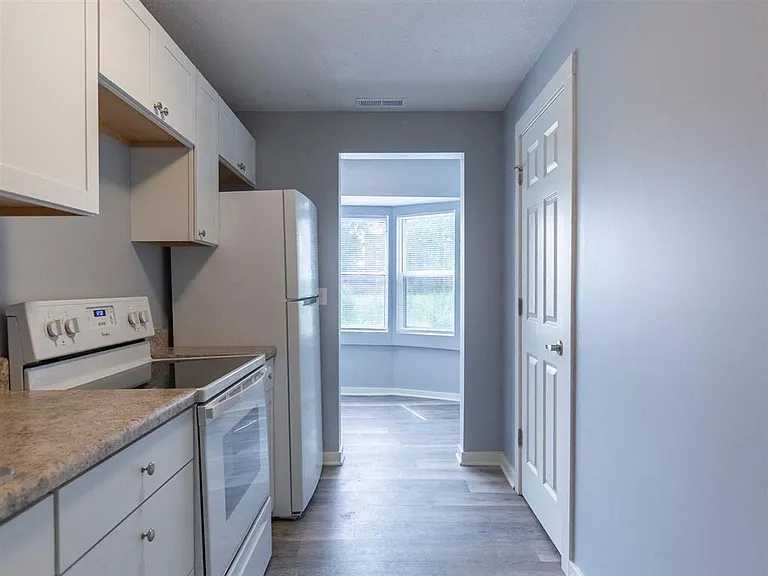 Kitchen with a white stove at Park Avenue Apartments.