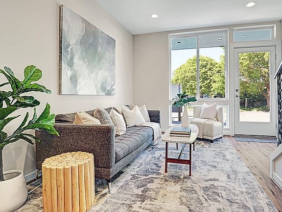 Tons of natural light throughout! First floor has a living, dining and kitchen + powder room!