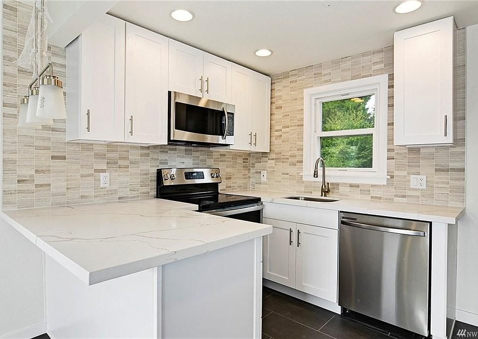 Brand New Kitchen with New Stainless Steel Appliances and designer tile (food disposal included)!