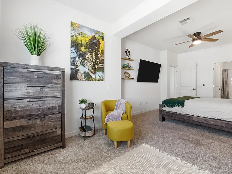 Spacious primary suite with plush bedding and thoughtful touches.