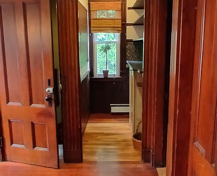 View from dining area into kitchen , highlighting natural woodwork & Cherry floors.