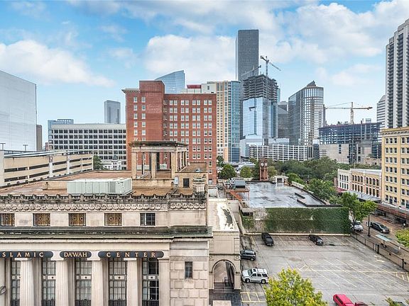 The phenomenal Downtown skyline view from bayou Lofts 7A! This scene can be seen from living/dining/kitchen and both bedrooms! Historic buildings in foreground with modern skyline in background!