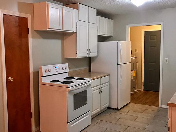 Kitchen, new stove, oven and refrigerator. Laundry room and back door entrance off the kitchen