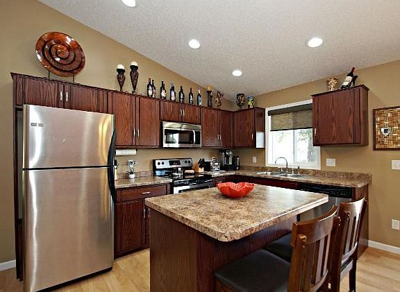 Kitchen has newer cabinets, center island with a breakfast area to enjoy your morning coffee, and ss appliances.