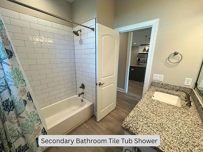 Secondary bathroom with tile tub shower combo