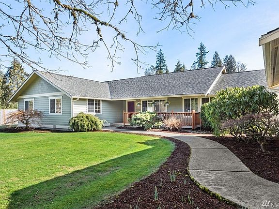 Mature landscaping and springtime flowers along the walkways welcome you home.