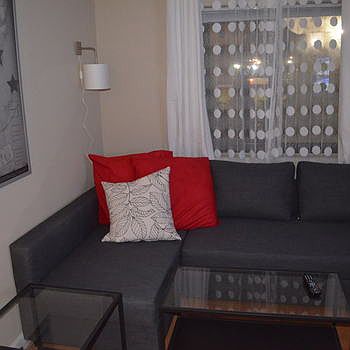 living room area with chaise sofa that has pull up to make i